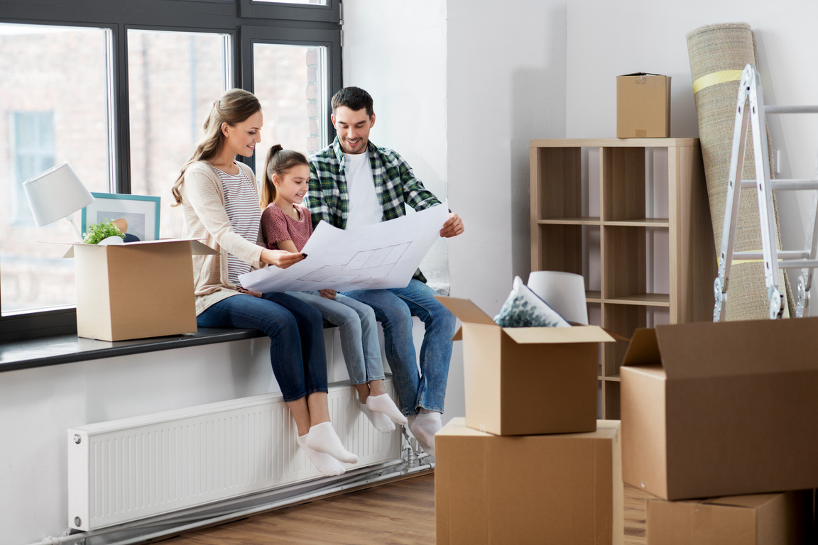 Happy Family with Blueprint Moving to New Home